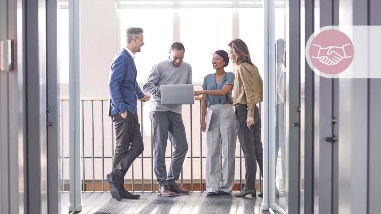 A group of professionals discussing in the office space